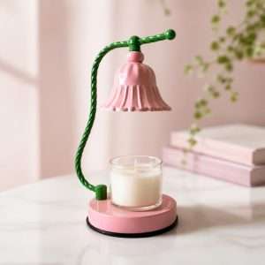 Glossy pink bell shade on a twisted green stem over a jar candle on a pink base, the GODONLIF pink candle warmer lamp