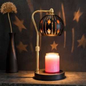 Black cut-out star globe lit over a pink jar candle on a round black base, GODONLIF celestial decor warmer lamp