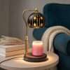 Star globe warmer lit beside a teal armchair and a knit throw, star decor on a round side table