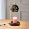 Angled view of the star globe warmer on a wood table, a star light lamp with a gold adjustable pole