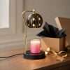 Star globe warmer lit next to a kraft box, gold ribbon and a brass star tag, one of our celestial gifts
