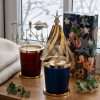 Unlit on a windowsill: white wax and bare wicks under the star and tree toppers, christmas table centerpiece decorations