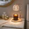 Crystal globe warmer lit on a marble nightstand with perfume and a brass tray, old Hollywood decor