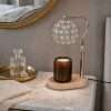 Unlit beaded globe of clear faceted crystals on a gold pole, a crystal candle lamp over an amber jar
