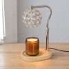 Angled view of the crystal globe warmer on a wood table, gold pole and oval base, Hollywood regency decor