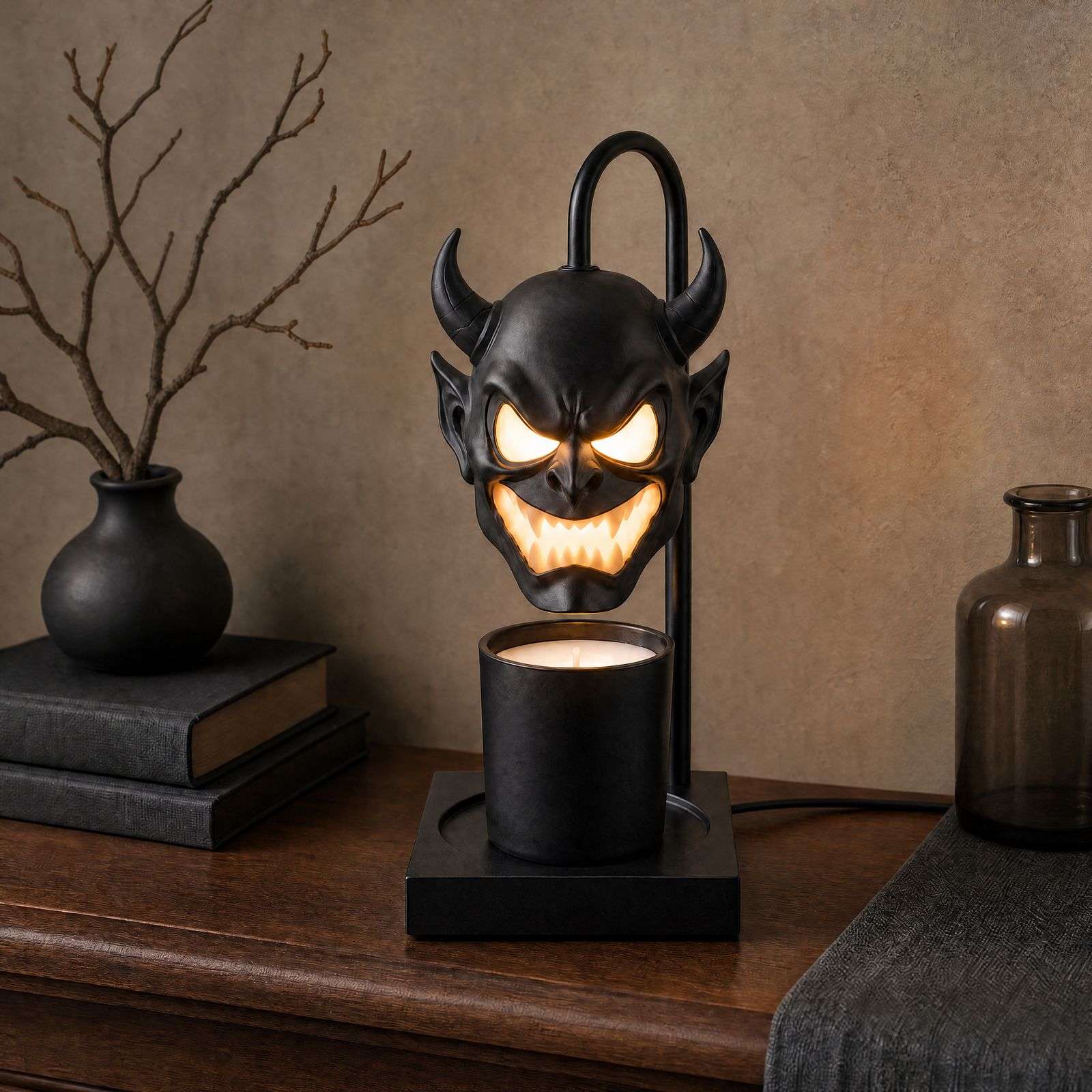 Black horned demon head with glowing eyes over a jar candle on a square base, the GODONLIF halloween candle warmer