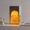White plaster block lit inside its arched niche with a David statue on a stone ledge, GODONLIF statue lamp