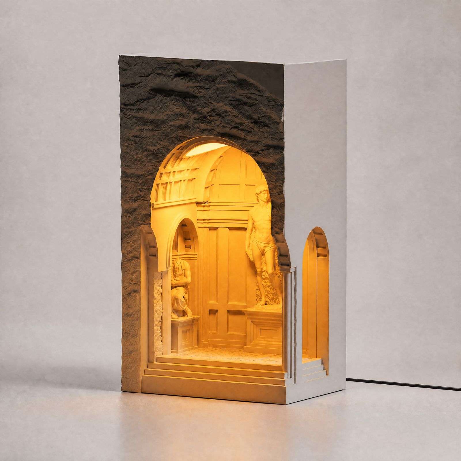 Studio three-quarter view of the arched niche lamp glowing warm against a neutral wall