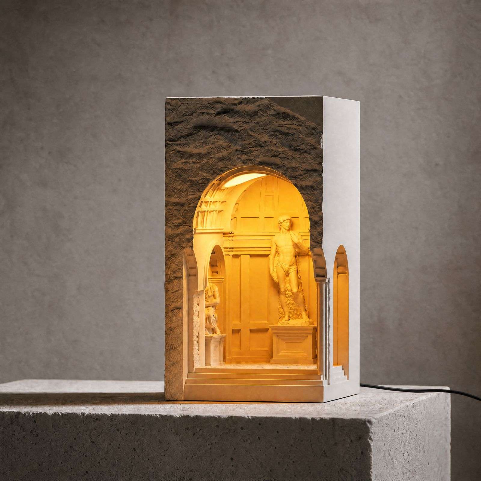 Dark studio shot of the David niche lamp glowing on a concrete plinth