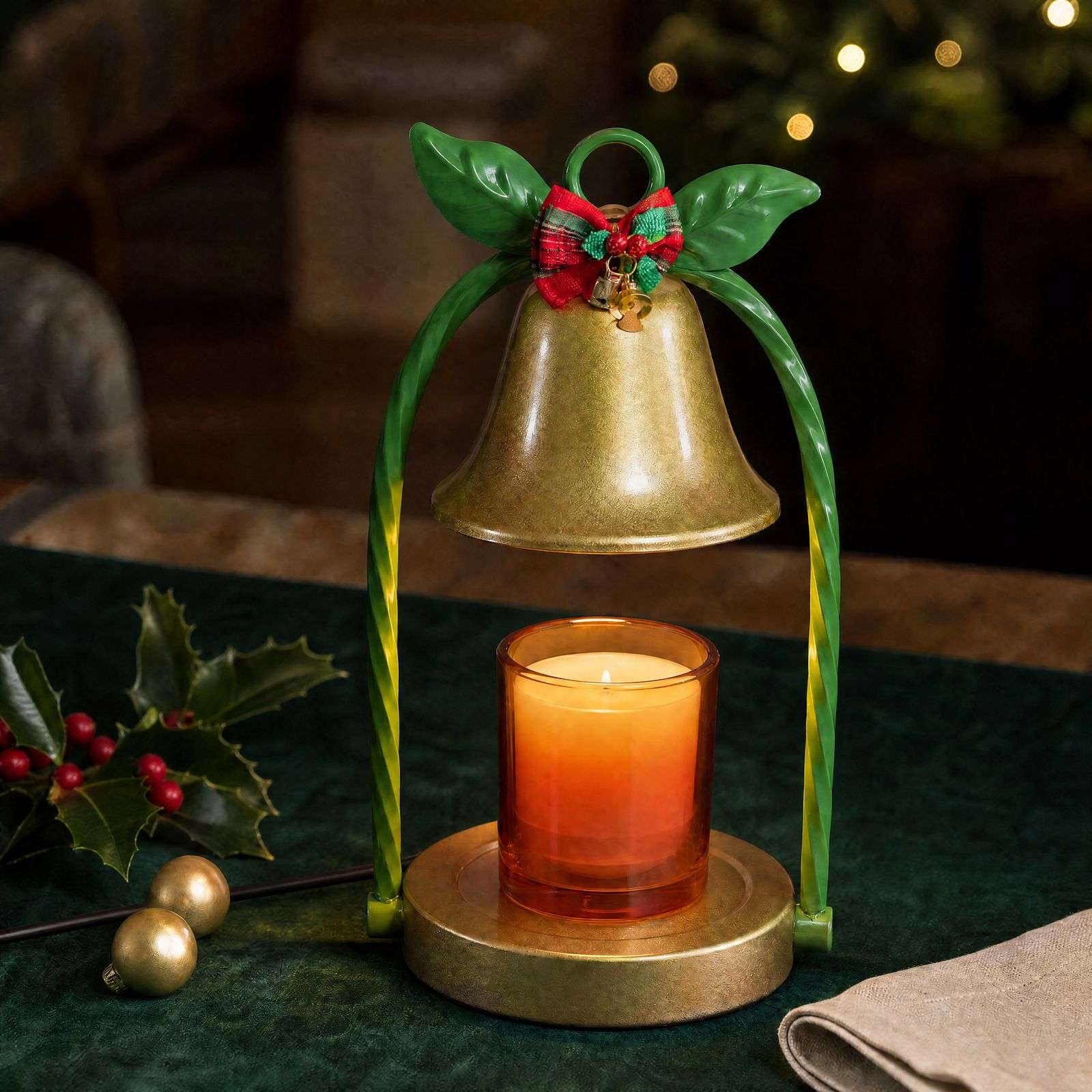 Gold bell shade between twisted green stems with a tartan bow, glowing over an amber jar candle, GODONLIF gold candle warmer