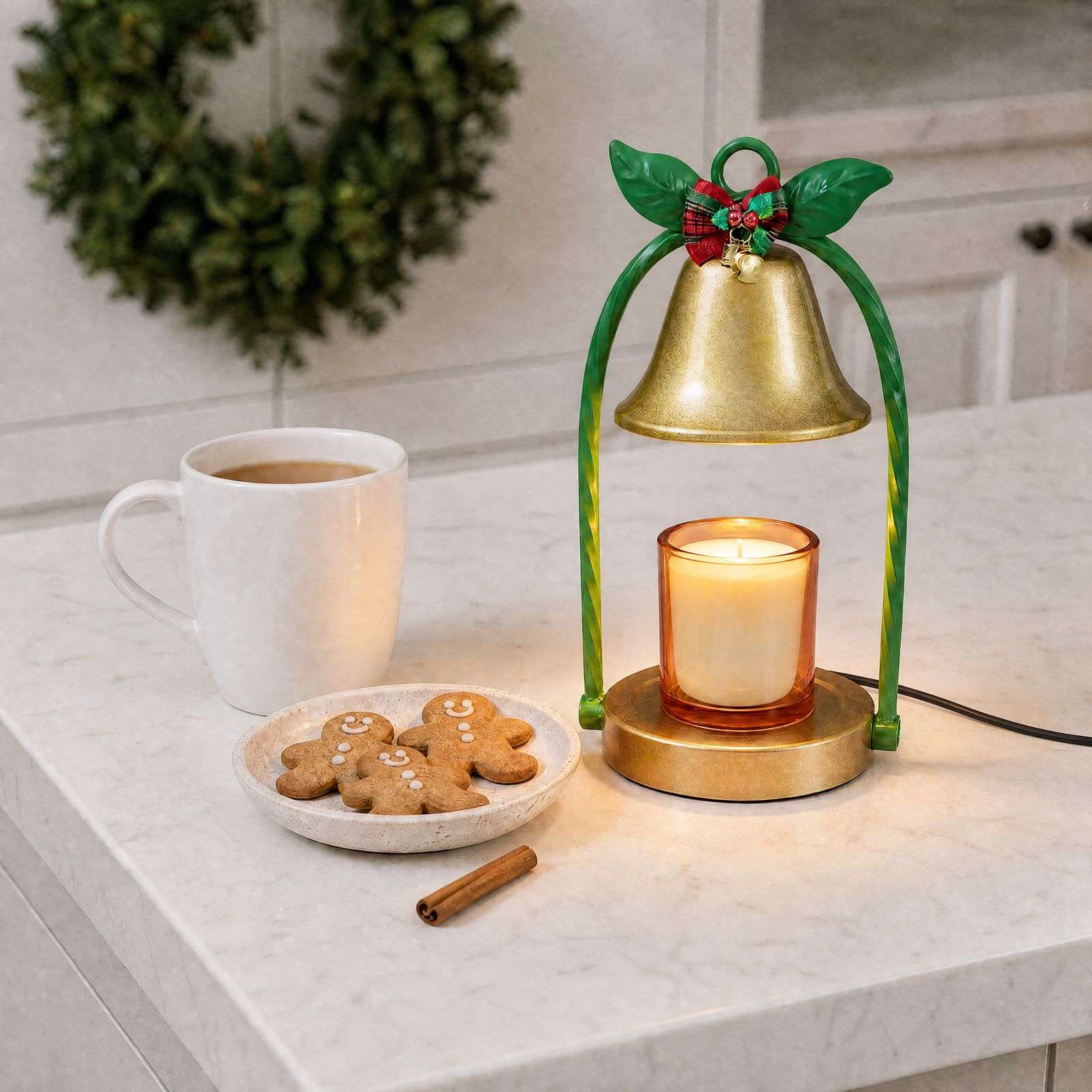 Bell warmer lit on a marble kitchen counter beside a mug and gingerbread men, a Christmas table lamp in daily use