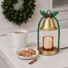Bell warmer switched off on marble, gold base and black foot ring visible, a black and gold candle warmer detail
