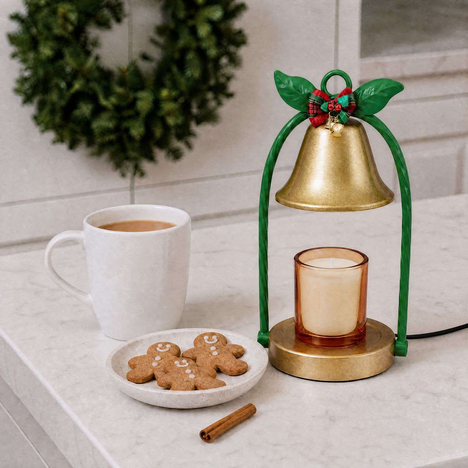 Bell warmer switched off on marble, gold base and black foot ring visible, a black and gold candle warmer detail