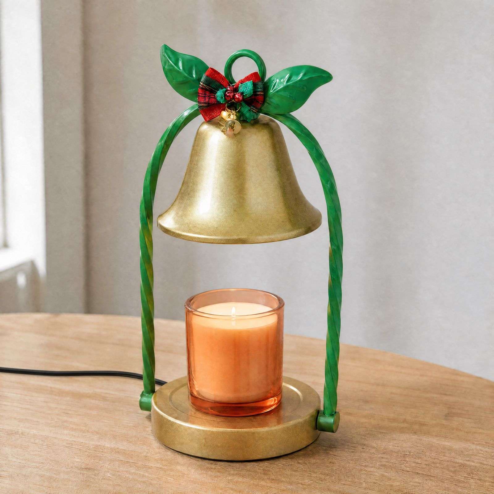 Three-quarter daylight view of the gold bell shade, twisted green stems, tartan bow and round gold base on wood
