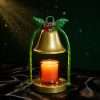 Close-up of the lit gold bell on black satin against a dark green backdrop with gold snowflakes, Christmas bell decor