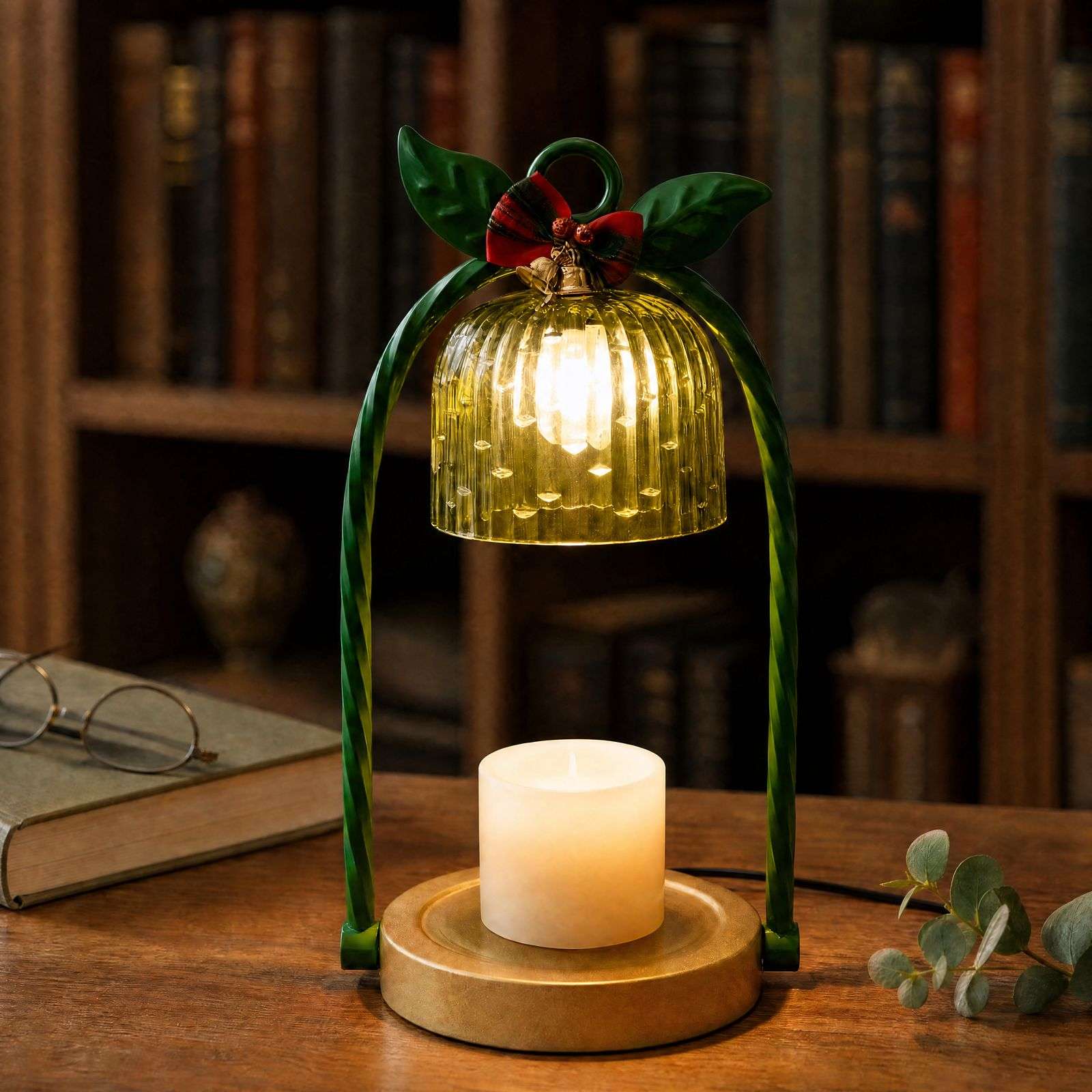 Lit green fluted glass bell over a white pillar candle on a round gold base, the GODONLIF green candle warmer