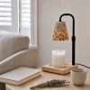 Unlit cone shade, one of our hand painted lamp shades, on a black arm over a white jar candle