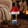 The same Santa hat lamp switched off, showing the knit-red hat, thick white fur brim, pom-pom and gold knurled collar