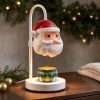 Sculpted Santa head shade glowing on a white hook pole over a green candle tin, GODONLIF Santa decor warmer lamp