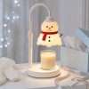 Snowman warmer glowing beside an open pale-blue gift box, ribbon and knitted mittens, snowman themed gifts ready to wrap